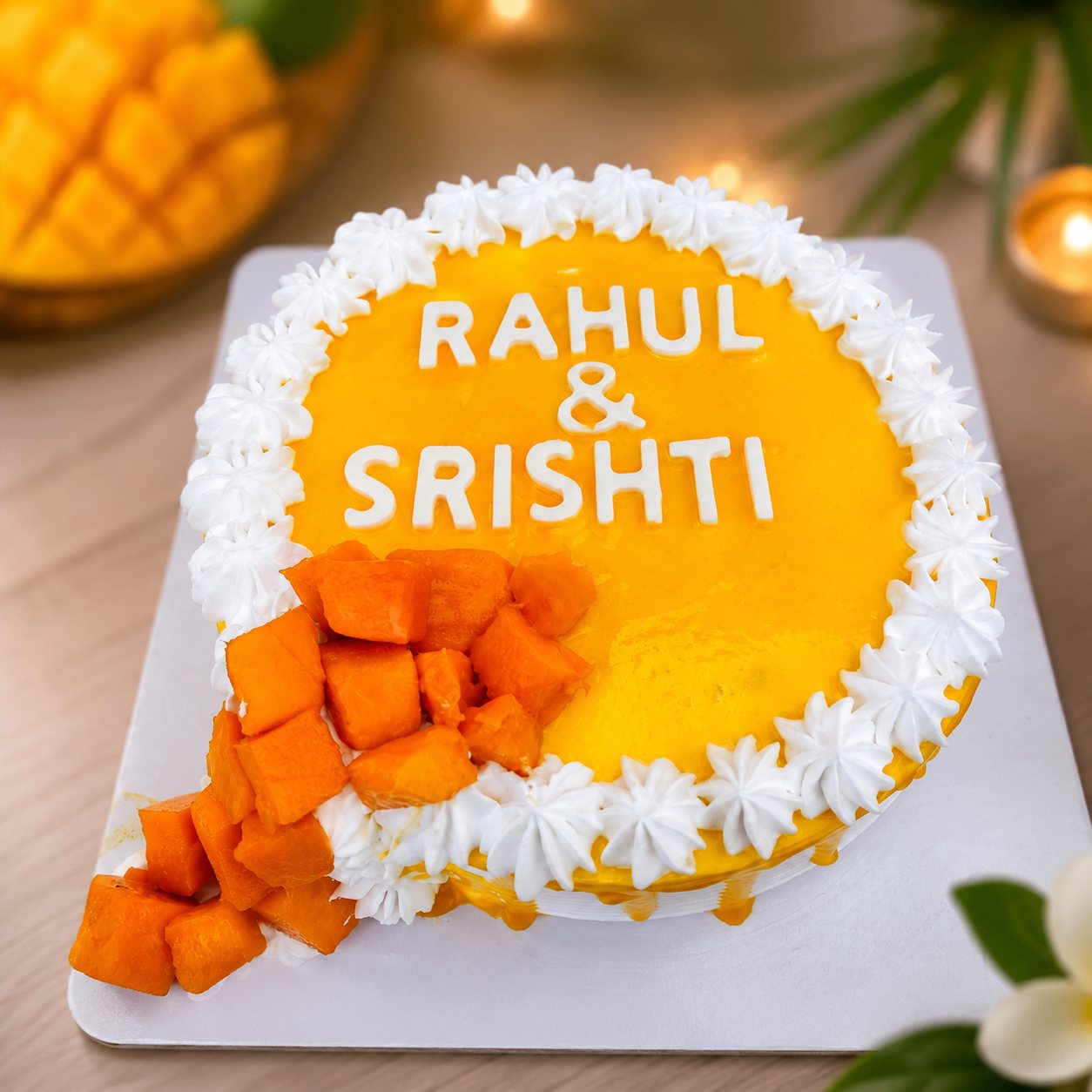Bright mango cake finished with whipped cream border and fresh mango cubes