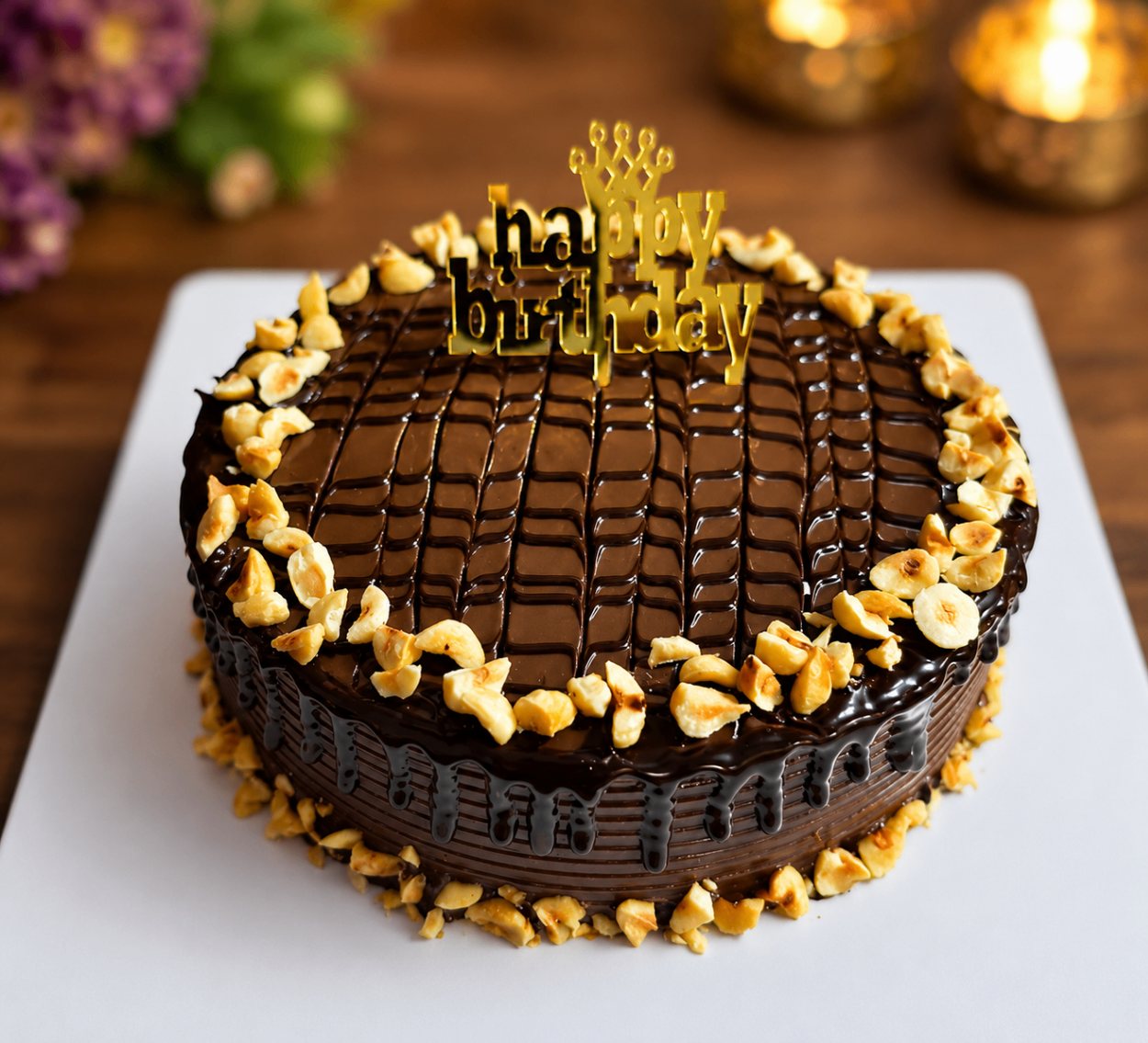 Chocolate cashew nut cake with glossy ganache drip and birthday topper