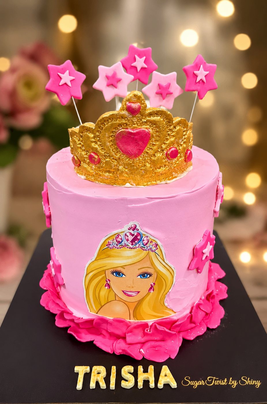 Pink princess birthday cake with golden crown and star toppers